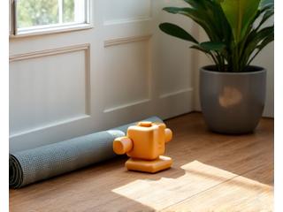 Compact home fitness equipment like resistance bands and light dumbbells in a minimalist living space.